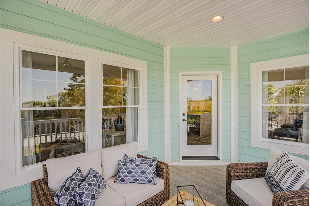 Green home exterior with large porch | Exteriors | Bay to Beach Builders | Greenwood, DE 19950