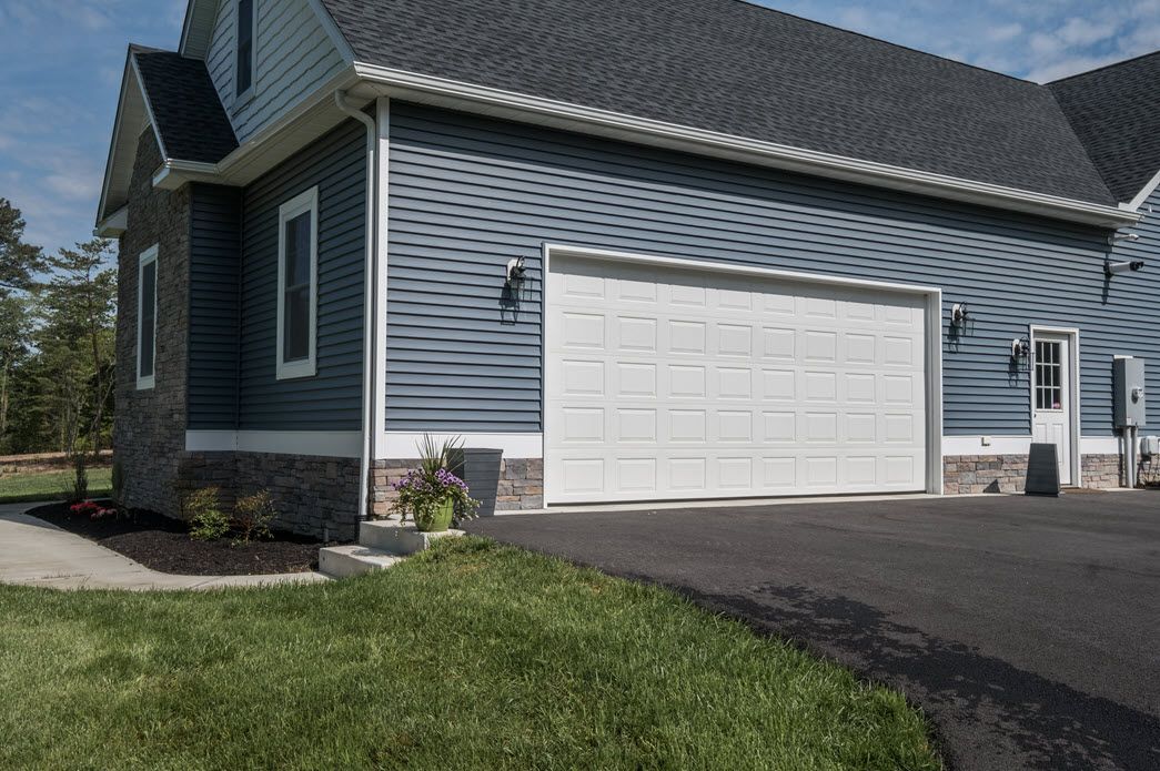 Blue home exterior with garage detail | Garages | Bay to Beach Builders | Greenwood, DE 19950