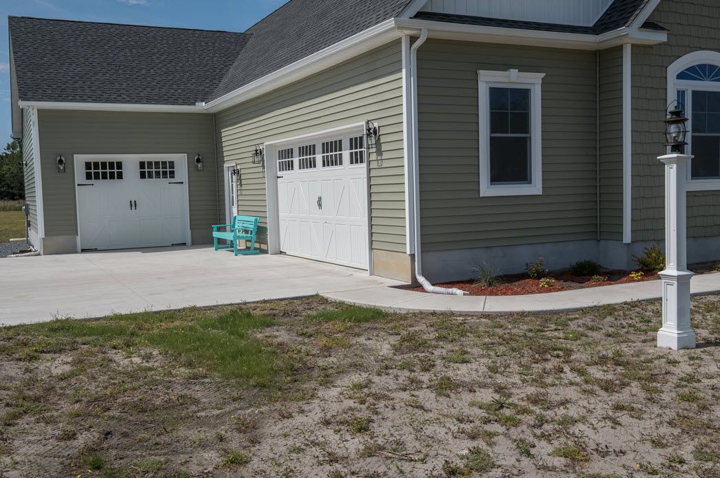 Green home exterior with garage detail | Garages | Bay to Beach Builders | Greenwood, DE 19950