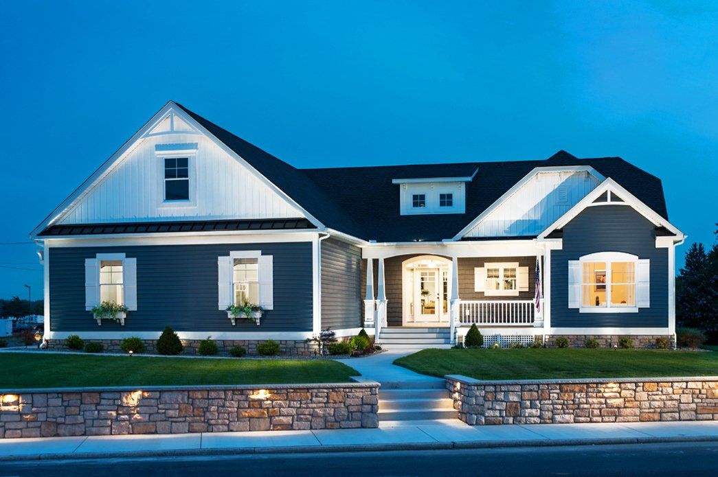 Blue home exterior with lights at night | Exteriors | Bay to Beach Builders | Greenwood, DE 19950