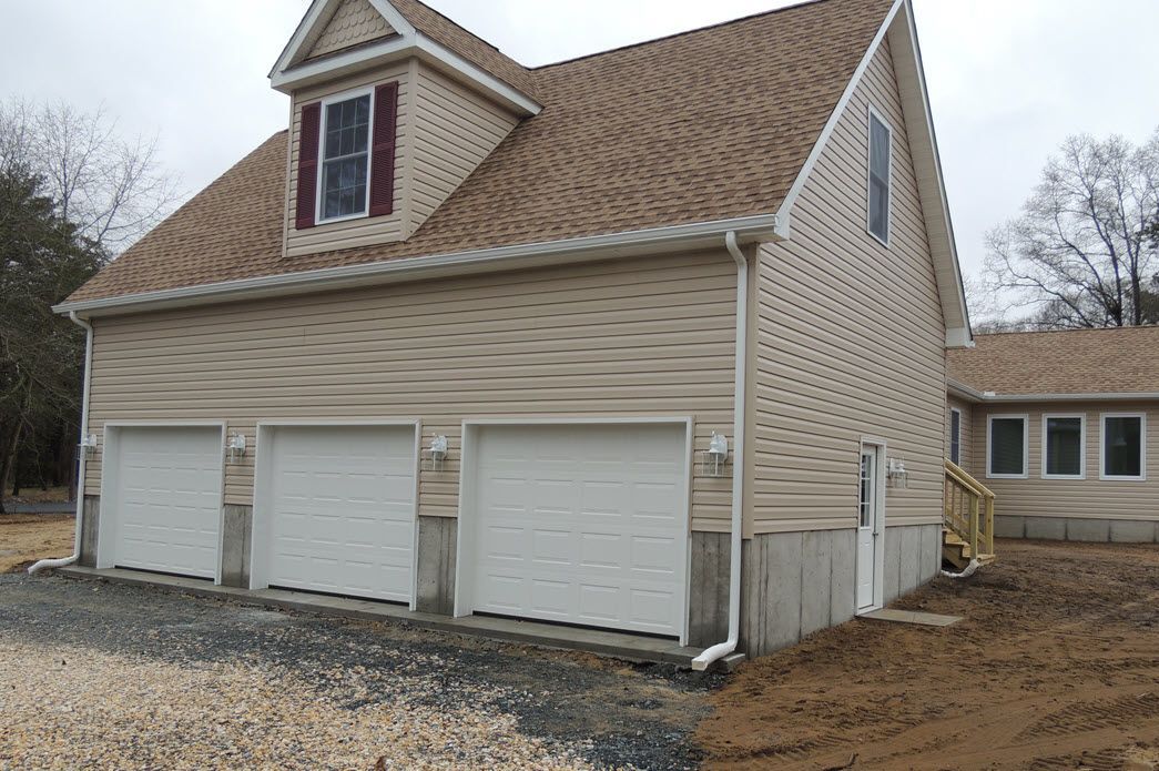 Tan home exterior with garage detail | Garages | Bay to Beach Builders | Greenwood, DE 19950