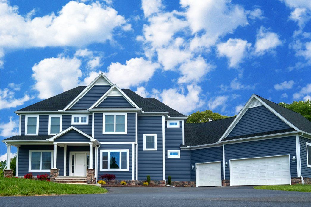 Blue home exterior with garage | Exteriors | Bay to Beach Builders | Greenwood, DE 19950