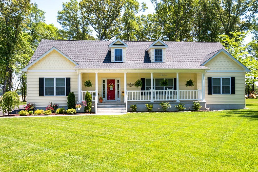Yellow home exterior with front porch | Exteriors | Bay to Beach Builders | Greenwood, DE 19950