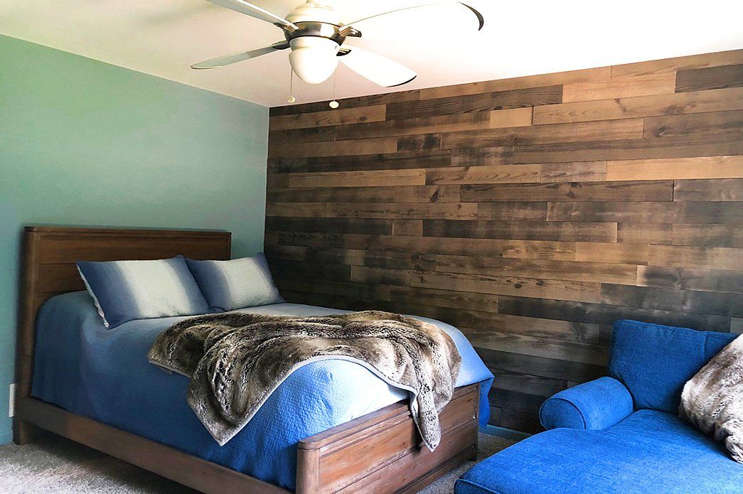 Bedroom with bed and wall treatment | Bay to Beach Builders | Greenwood, DE 19950
