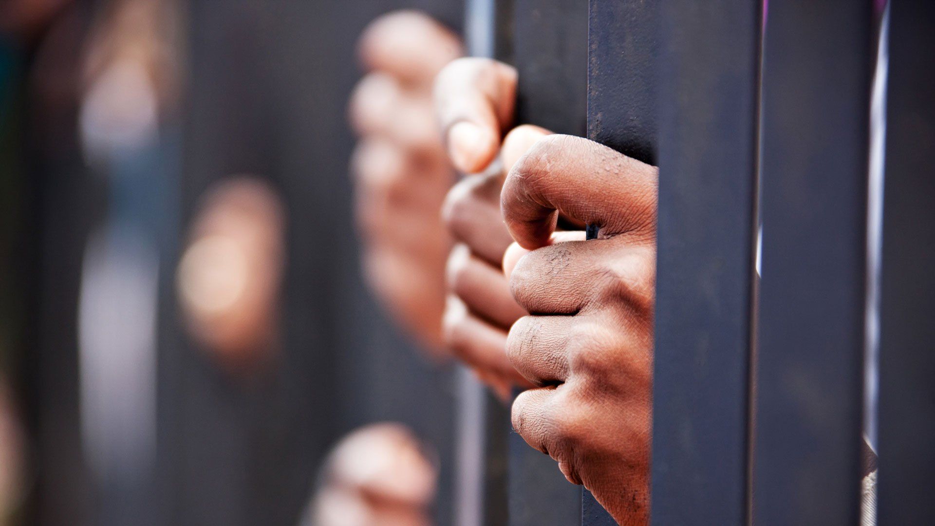 Hands Holding Prison Bars — Inglewood, CA — 1 On 1 Bail Bonds