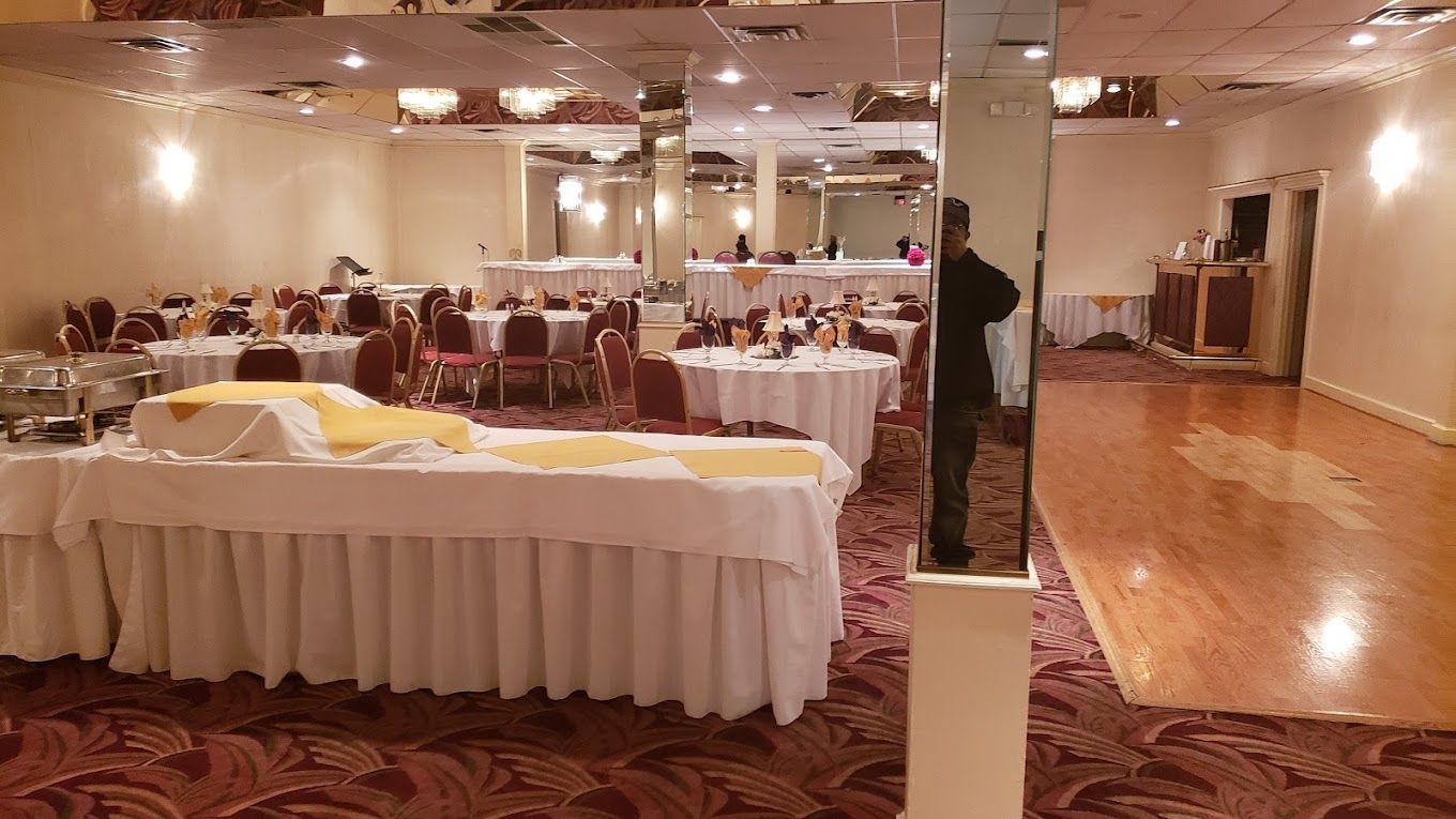 A large room with tables and chairs and a dance floor