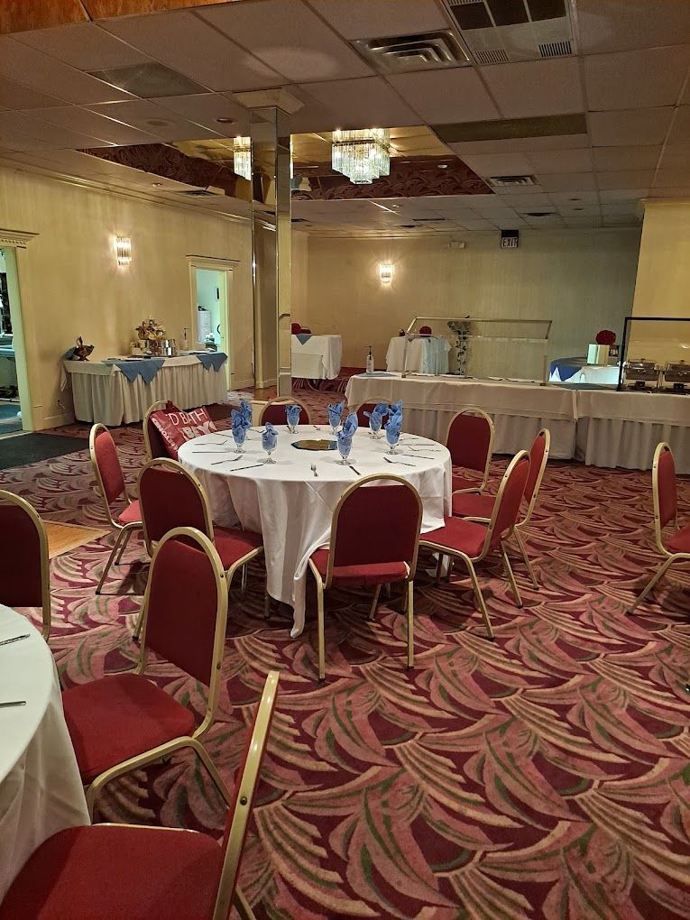 A large room with tables and chairs set up for a party