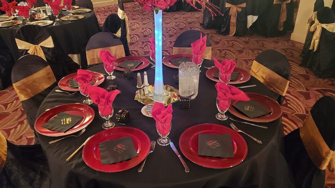 A table with plates , napkins , glasses , and a candle on it