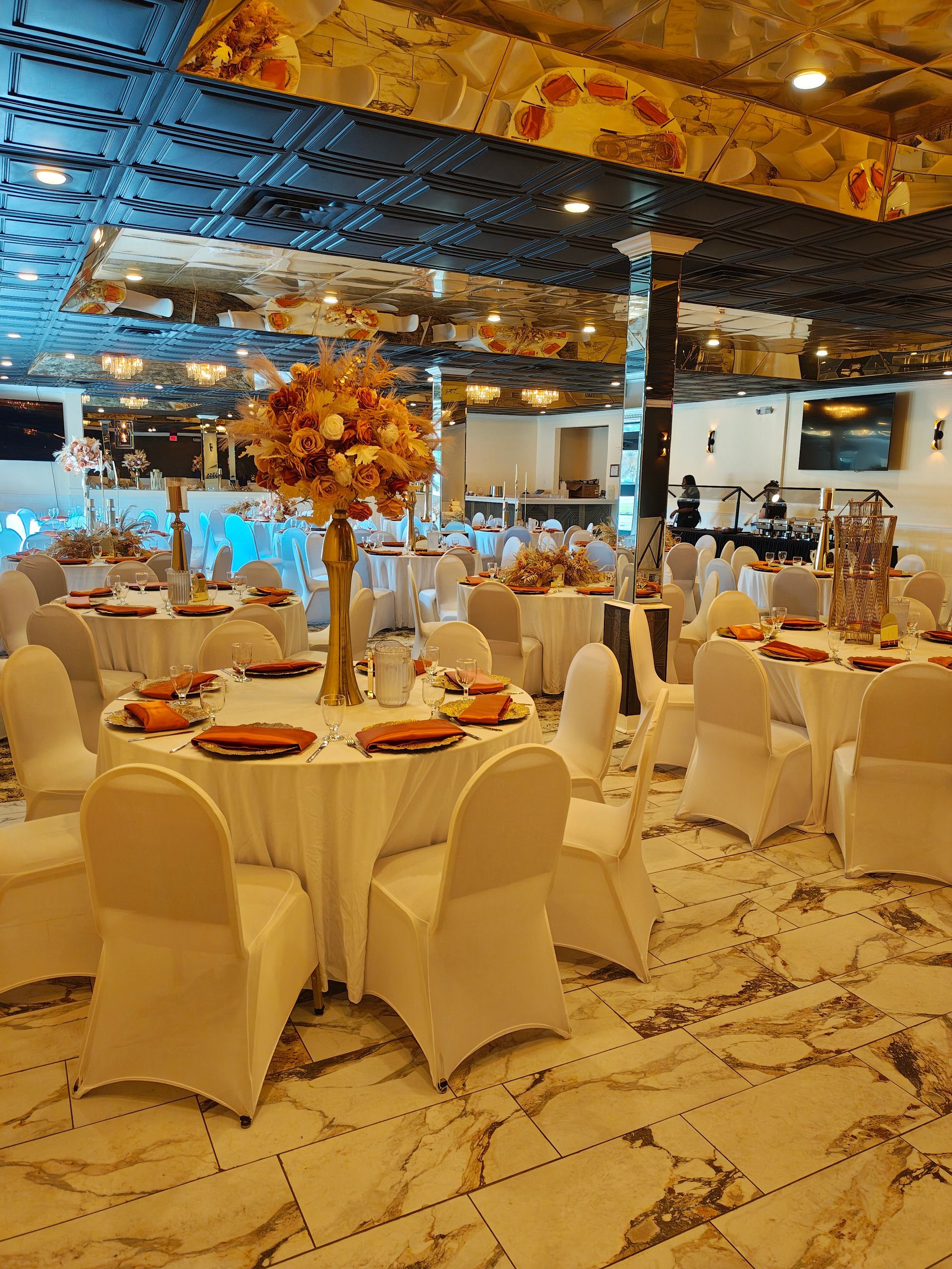 A long table with blue napkins and plates on it