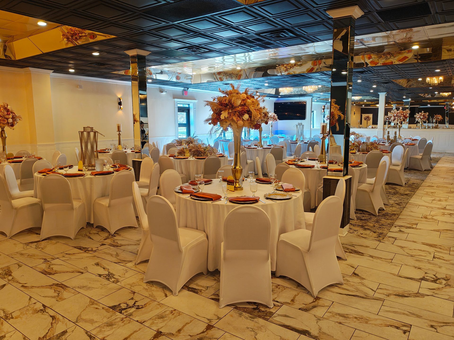 A large room with tables and chairs set up for a party