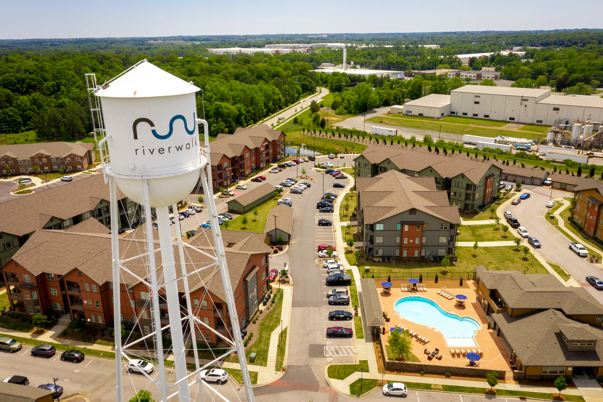 Aerial view of an apartment complex with a prominent white water tower labeled 