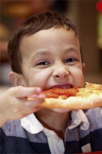 Kid Eating Pizza — Columbus, OH — Plank's Cafe & Pizzeria