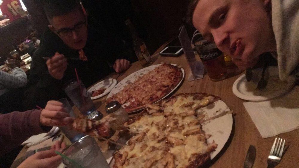 Friends Eating Pizza — Columbus, OH — Plank's Cafe & Pizzeria
