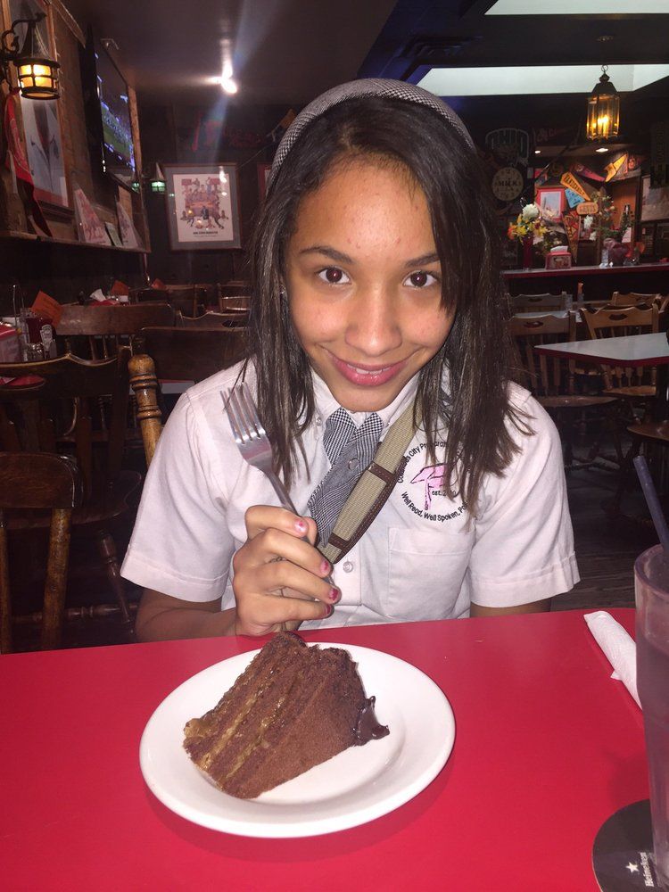 Woman With Cake On Table — Columbus, OH — Plank's Cafe & Pizzeria