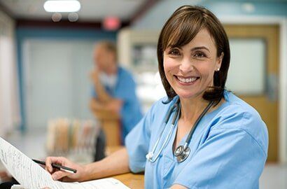 Female Doctor Holding Medical Records — Medical Practice in Aurora, CO