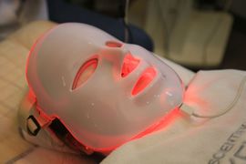 A dentist using a handpiece on a patient’s teeth during a dental exam