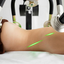 Physiotherapy device massaging a person's bent leg with green laser lines visible