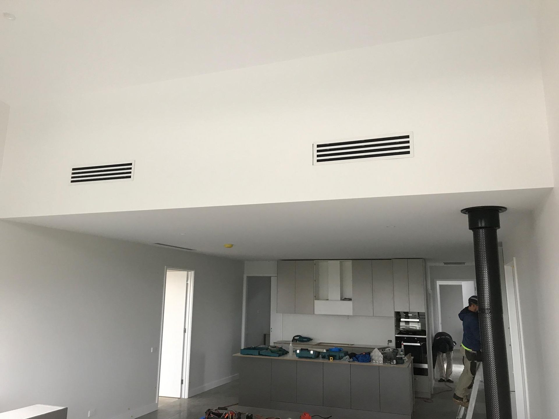 A Kitchen With White Cabinets And A Black Chimney — Custom Air In East Albury, NSW