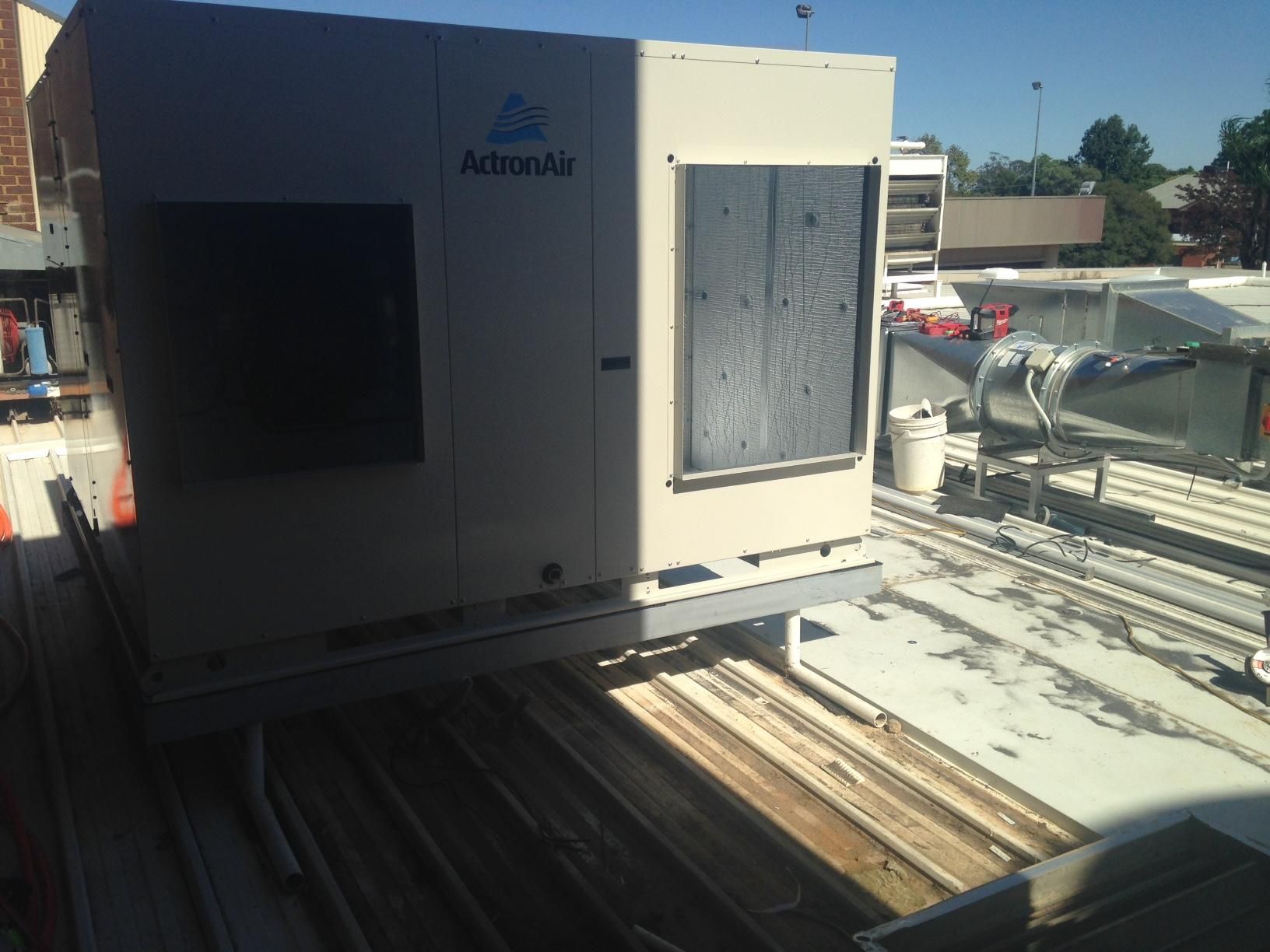An Air Conditioner Is Sitting On The Roof Of A Building — Custom Air In Yackandandah, NSW