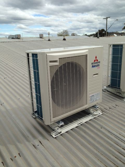 A Mitsubishi Air Conditioner Is Sitting On Top Of A Metal Roof — Custom Air In East Albury, NSW