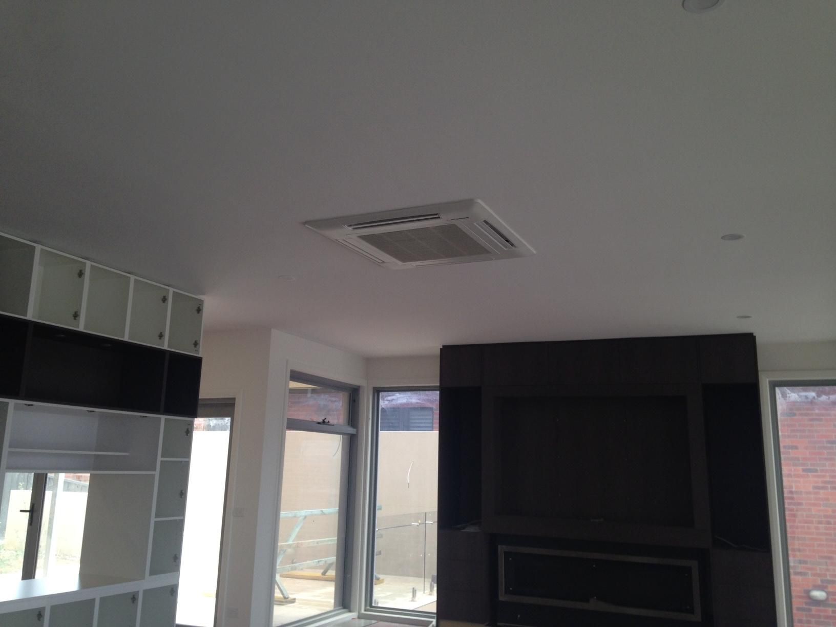 A Living Room With A Fireplace And A Cassette Air Condition — Custom Air In Albury, NSW