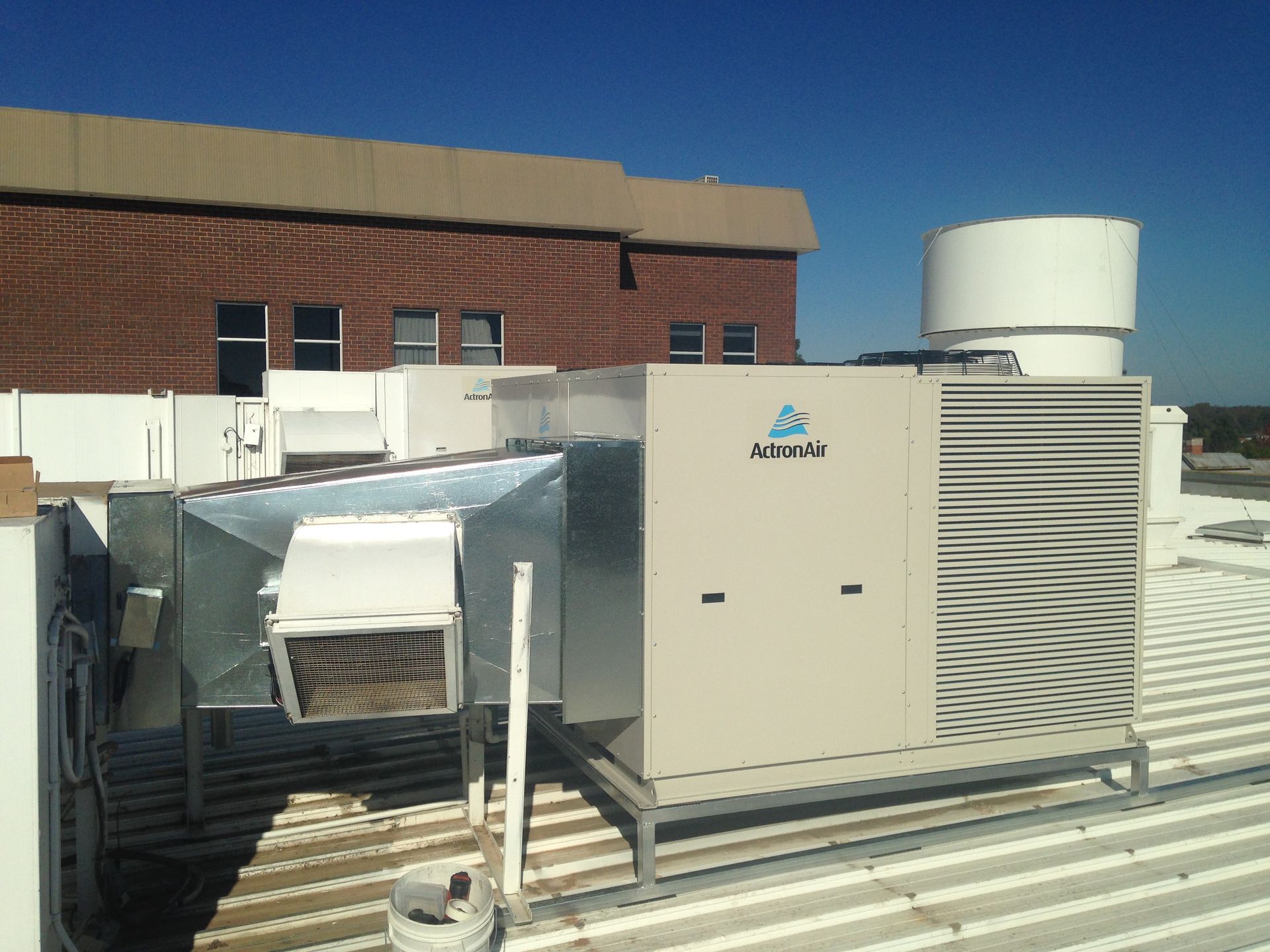A Coolair Air Conditioner Is On The Roof Of A House — Custom Air In East Albury, NSW