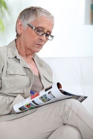 woman reading magazine at dental appointment