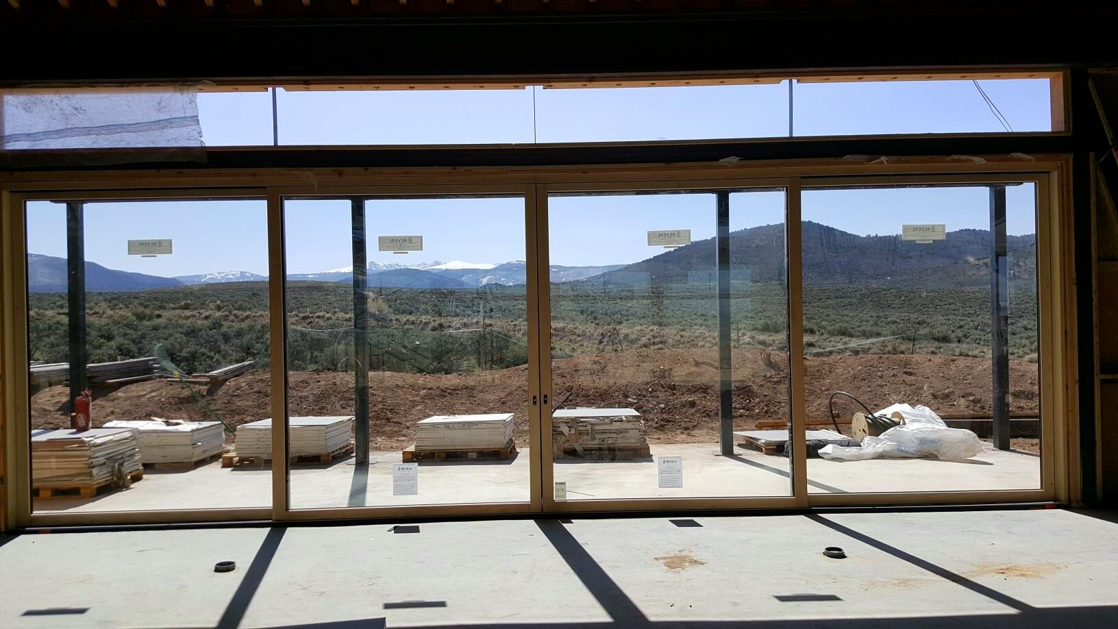 Large window with a stunning mountain range view, allowing natural light into the room.