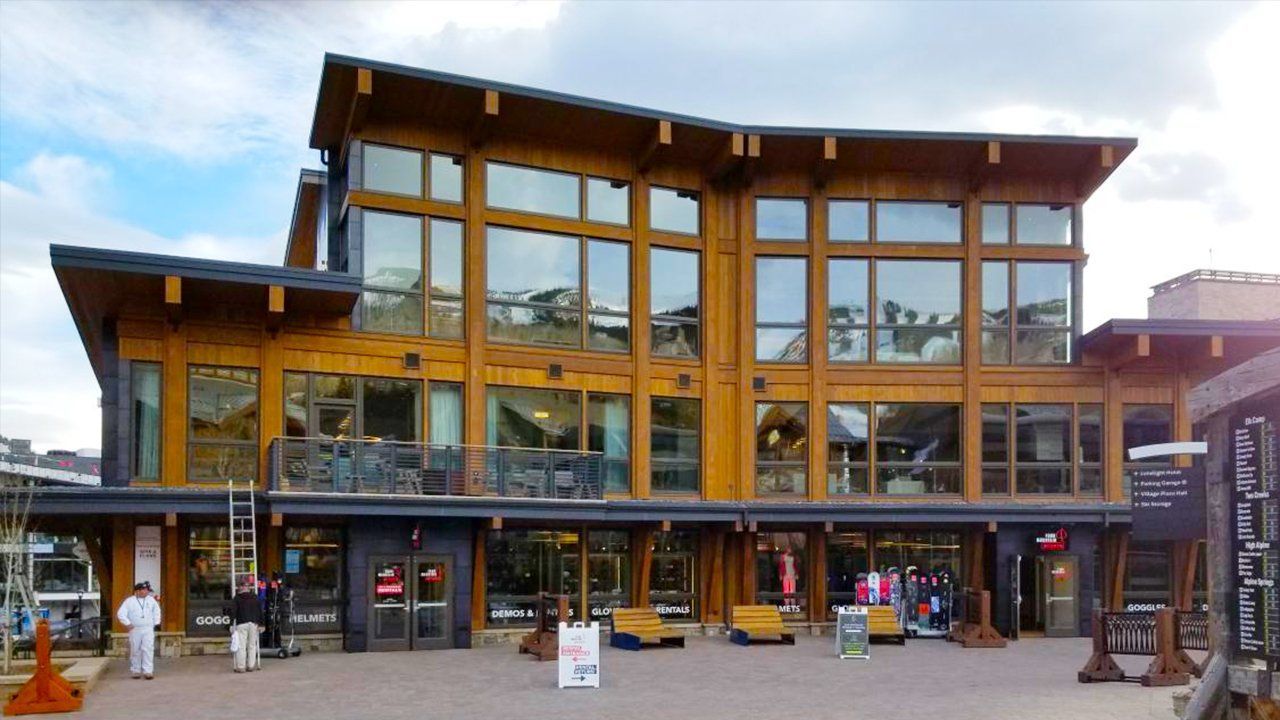 A large wooden building with a lot of windows.