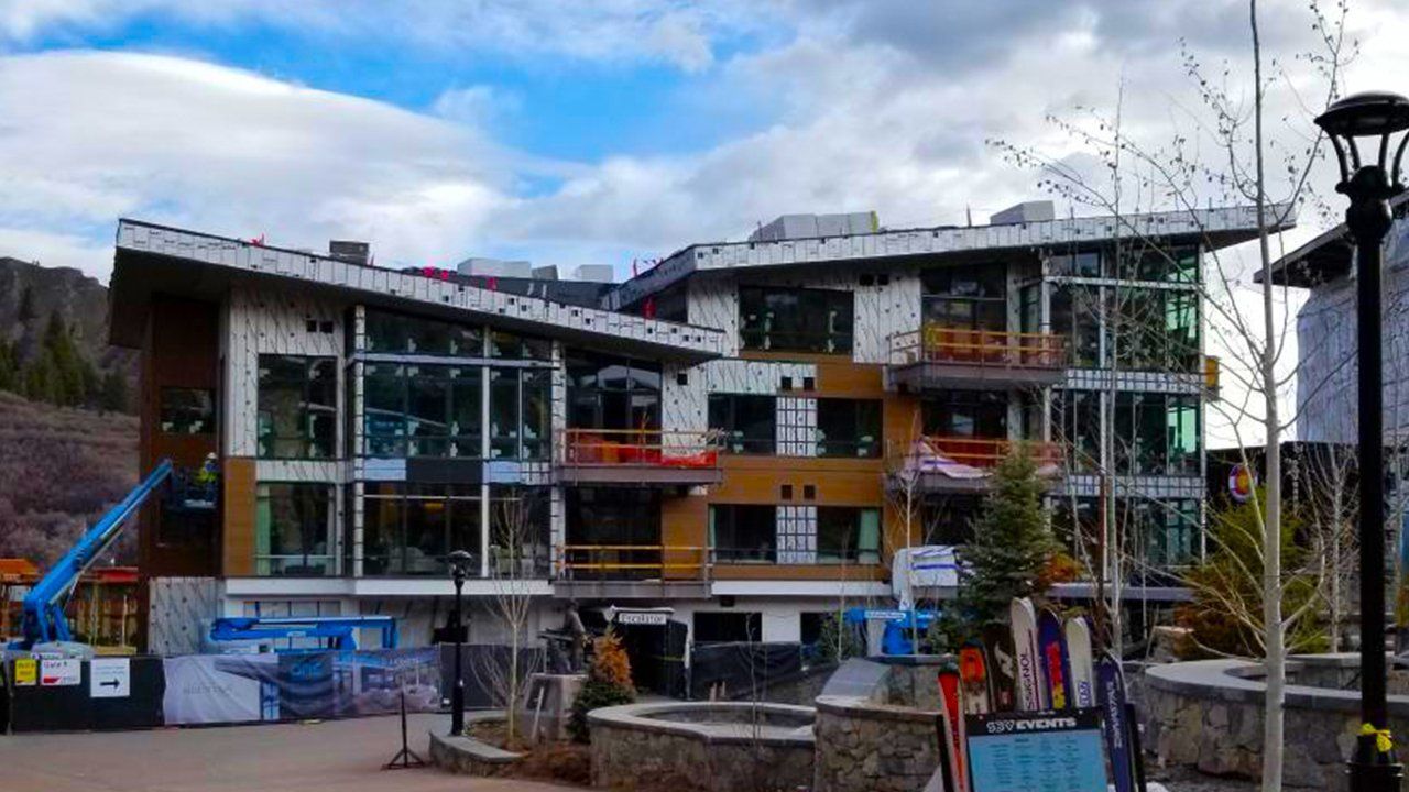 A large building featuring numerous windows that is currently under construction.