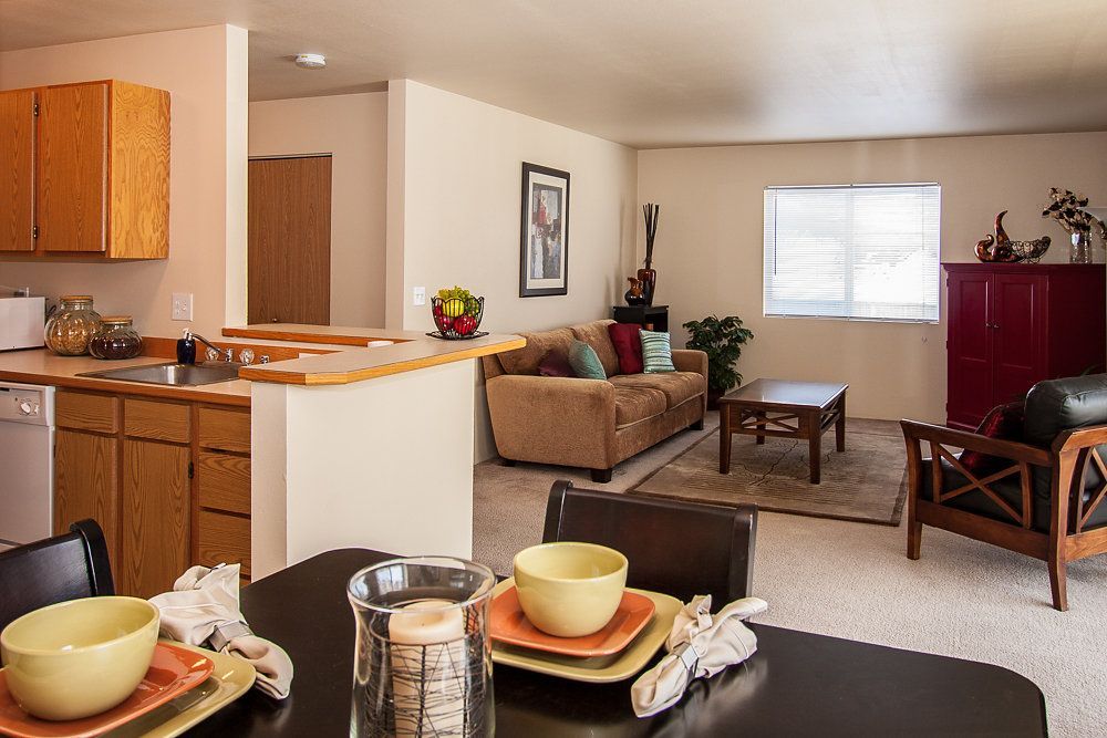 a living room with a dining table and a couch