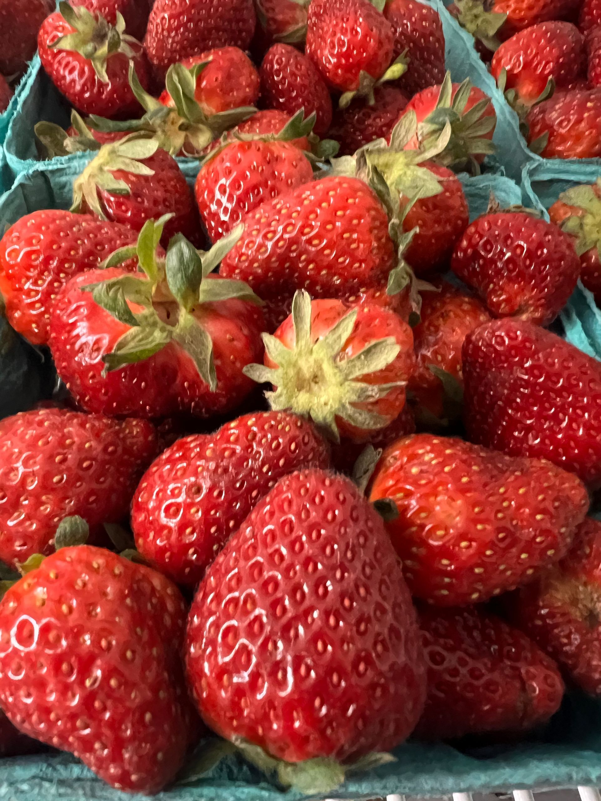 A bunch of strawberries are sitting on a table