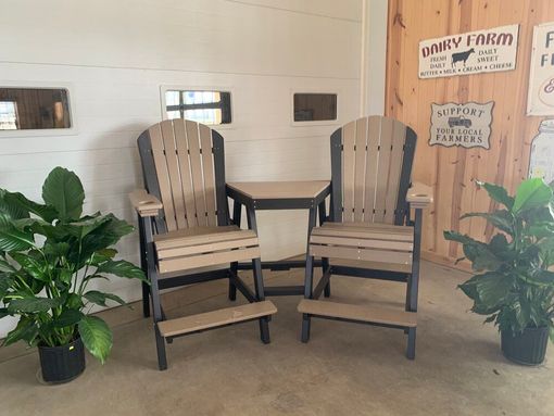 Two chairs and a table in a room with a sign that says dairy farm