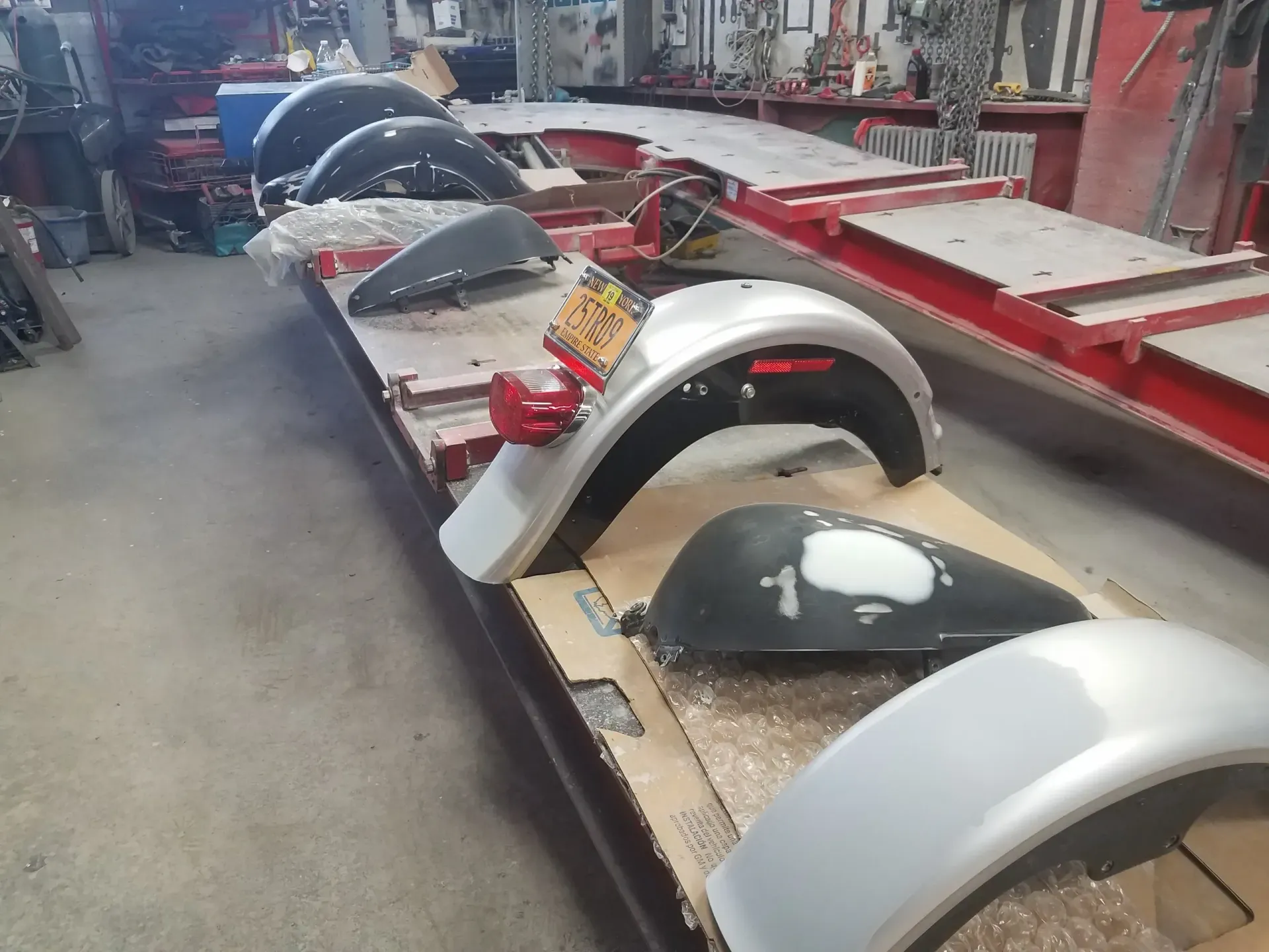 a row of motorcycle fenders are lined up on a table