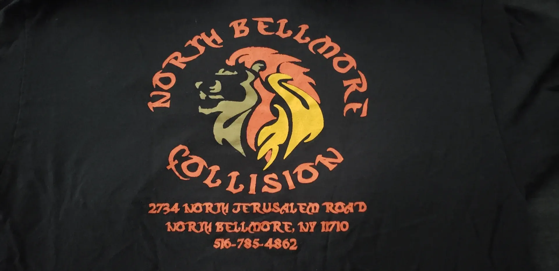 a black shirt with a lion on it that says north bellmore collision