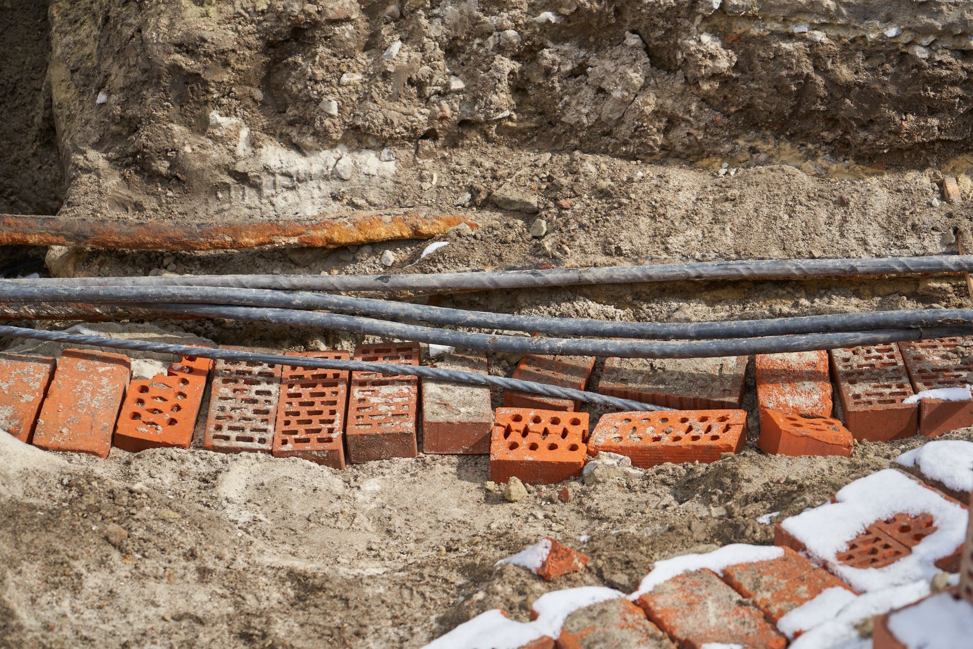 Person on ladder installing ceiling light.