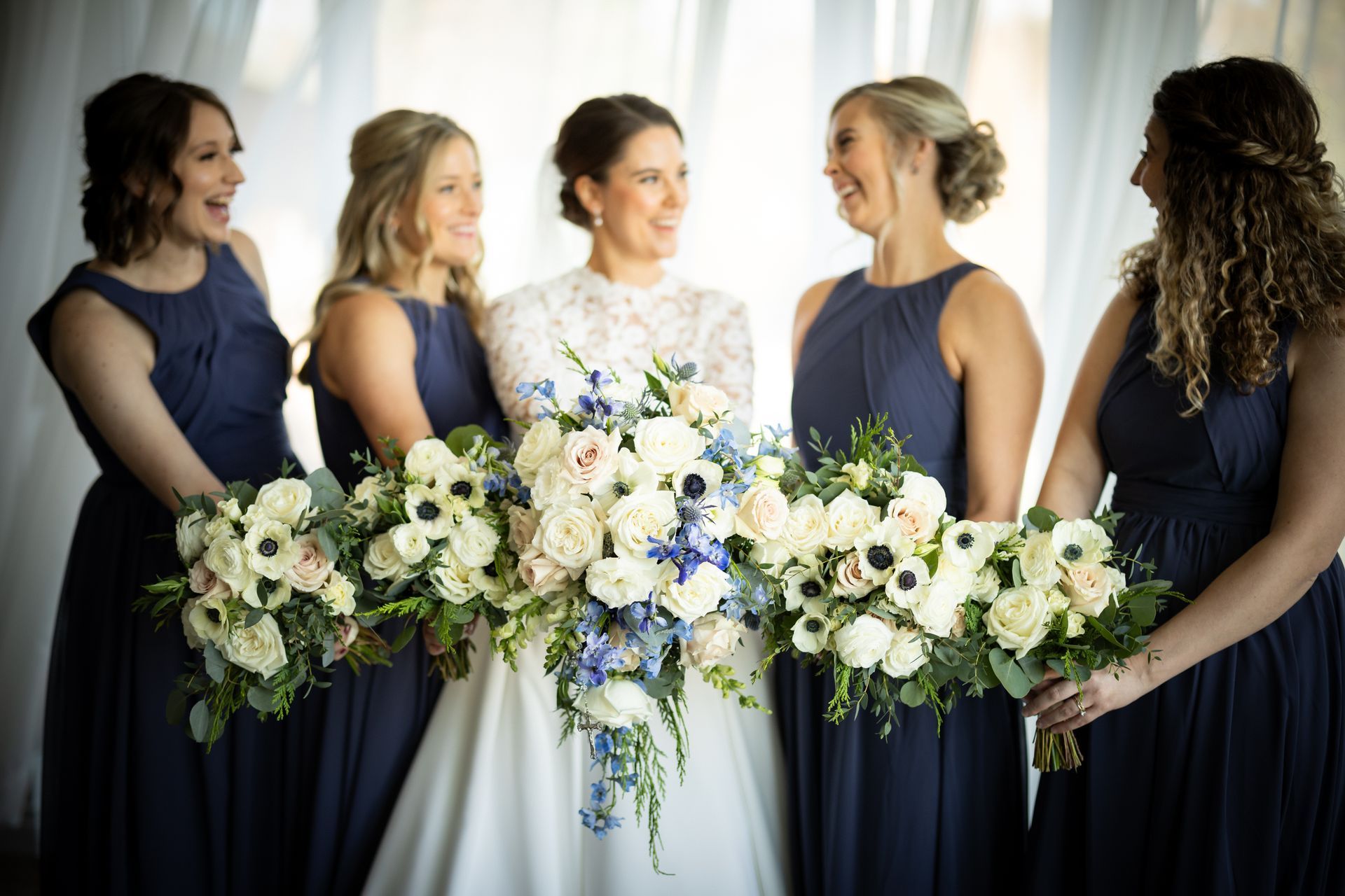 a bride and her bridesmaids are standing next to each other holding bouquets of flowers . natural wedding makeup. pittsburgh, pa. bridal makeup. bridal mua. wedding makeup artist. moriah e beauty. adam michaels photography.