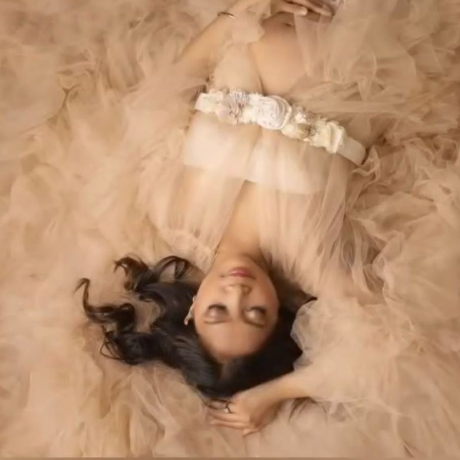 a woman in a robe is laying on her back on a bed . natural makeup. pittsburgh, pa. maternity makeup. bridal mua. wedding makeup artist. moriah e beauty. kristin merck photography.