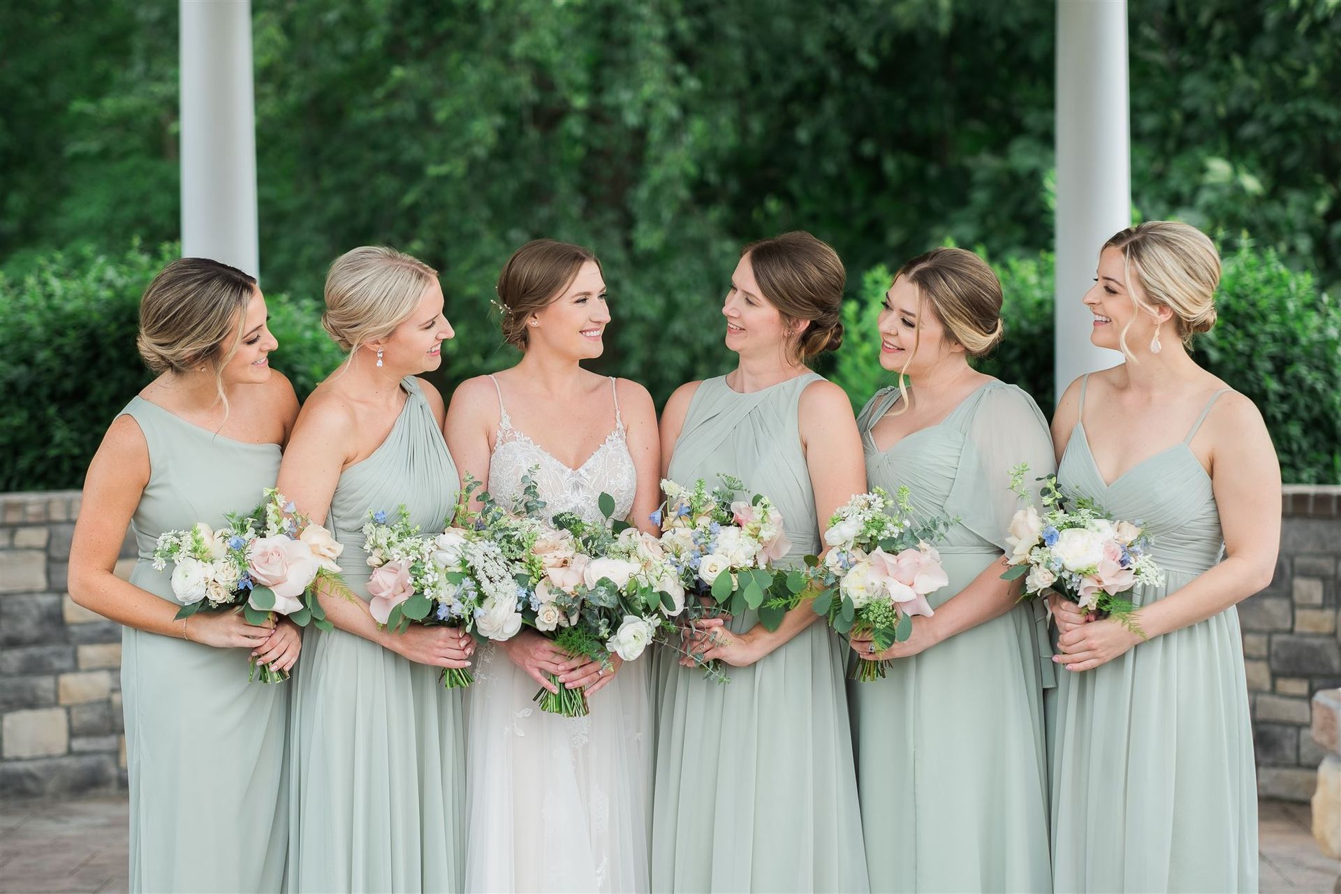 a bride and her bridesmaids are posing for a picture together . natural wedding makeup. pittsburgh, pa. bridal makeup. bridal mua. wedding makeup artist. moriah e beauty. caitlin's living photography.