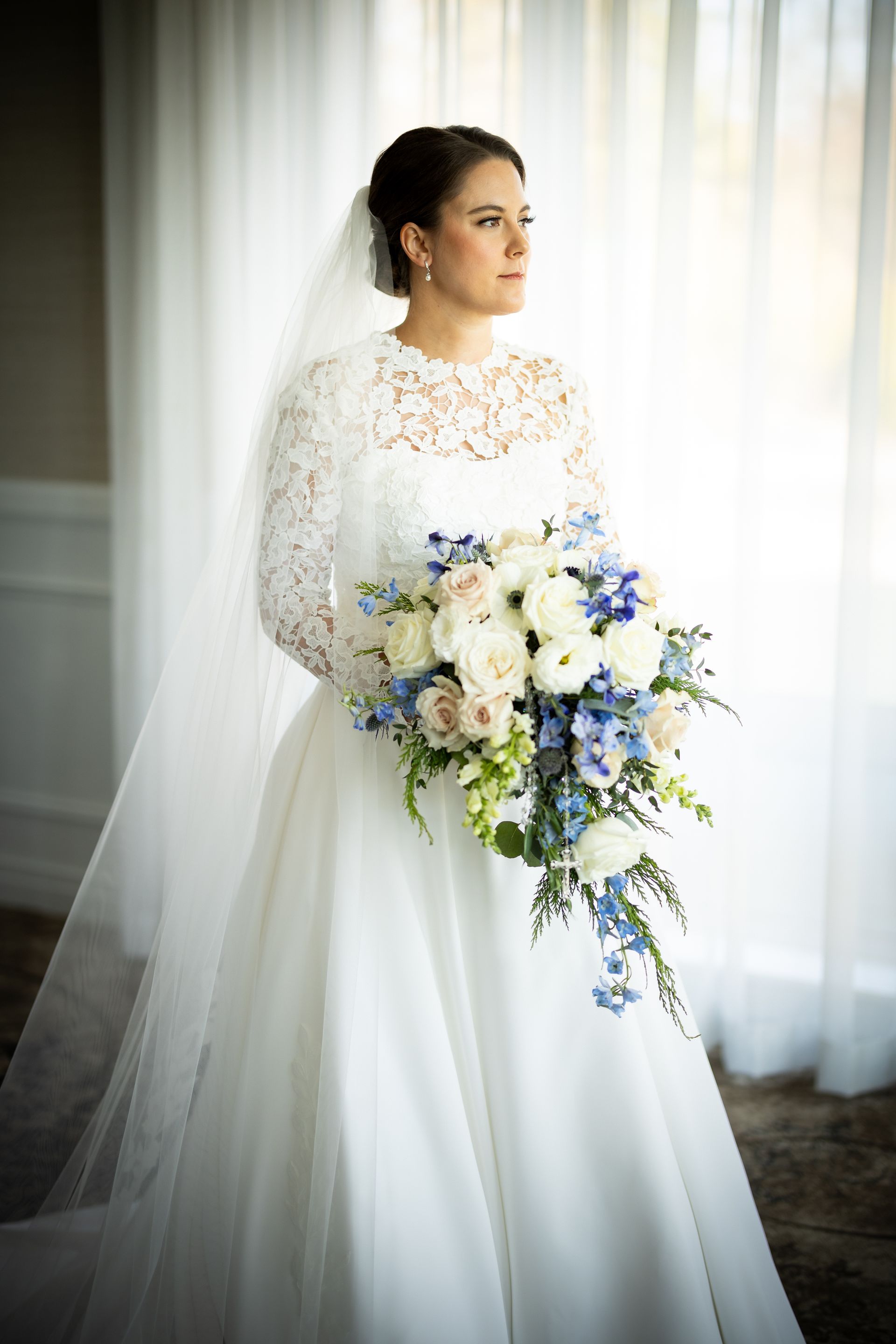 a bride in a white dress and veil is holding a bouquet of flowers . natural wedding makeup. pittsburgh, pa. bridal makeup. bridal mua. wedding makeup artist. moriah e beauty. adam michaels photography.