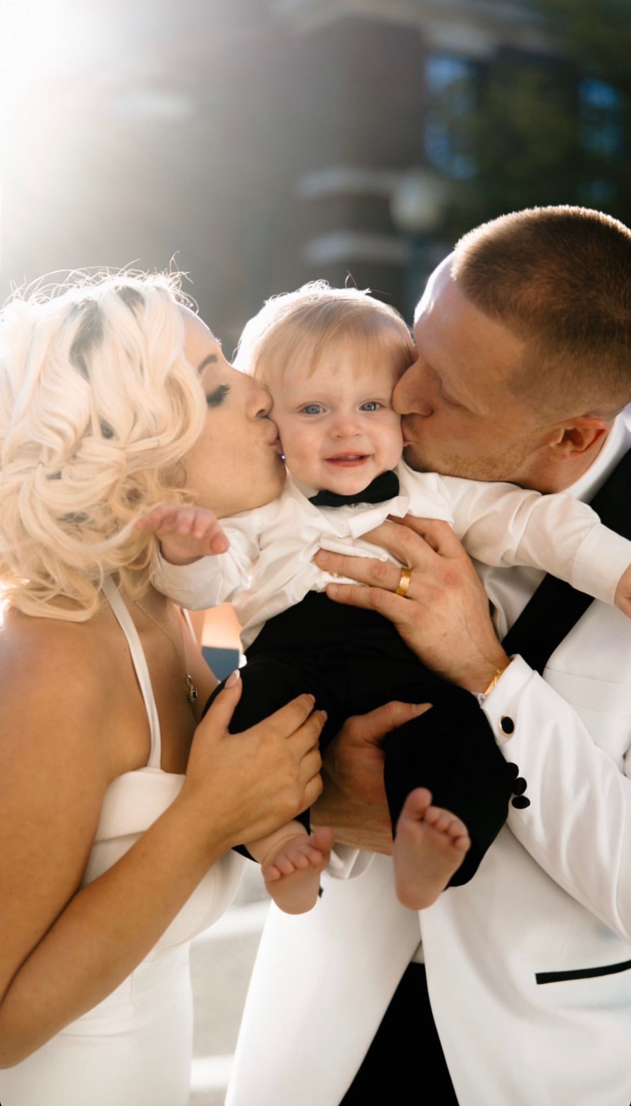 a bride and groom are kissing their baby on the cheek . soft glam wedding makeup. pittsburgh, pa. bridal makeup. bridal mua. wedding makeup artist. moriah e beauty. alexa frankovitch photography.