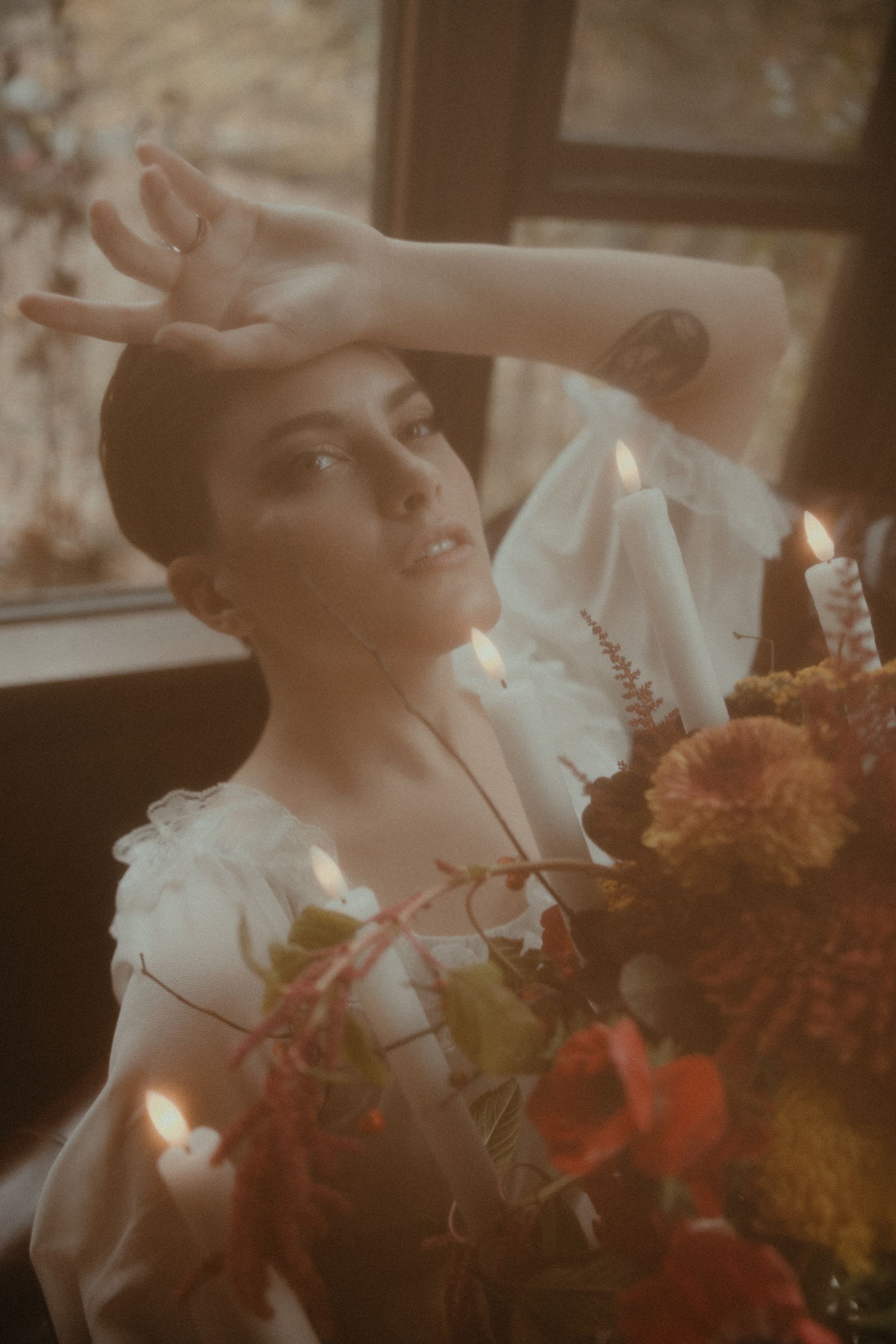 a woman in a white dress is holding a bouquet of flowers and candles . glam wedding makeup. pittsburgh, pa. bridal makeup. bridal mua. wedding makeup artist. moriah e beauty. snaps by shawna photography.