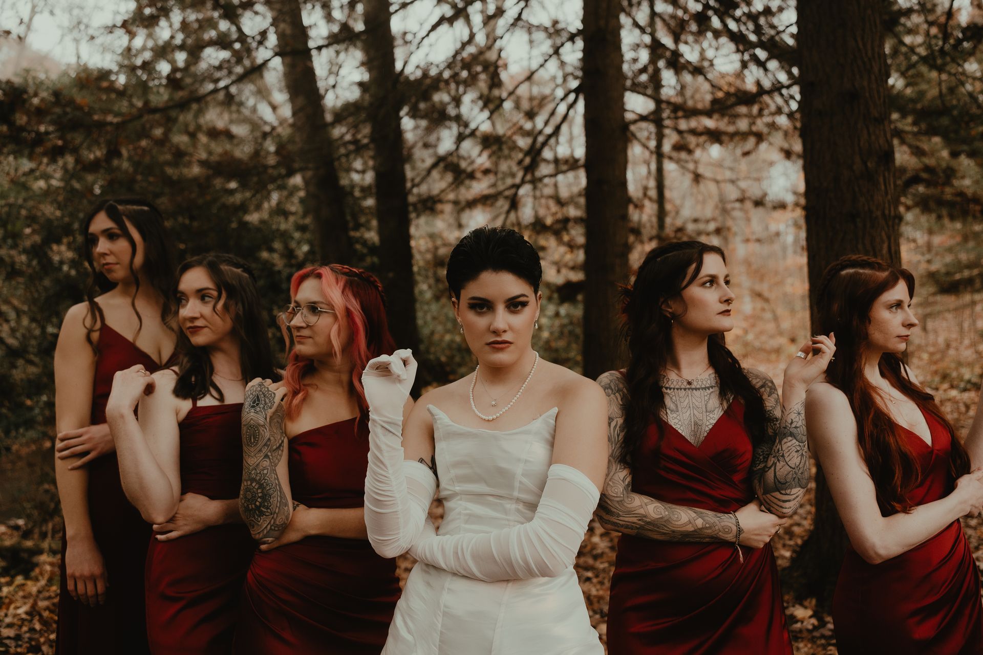a bride and her bridesmaids are posing for a picture in the woods . glam wedding makeup. pittsburgh, pa. bridal makeup. bridal mua. wedding makeup artist. moriah e beauty. snaps by shawna photography.