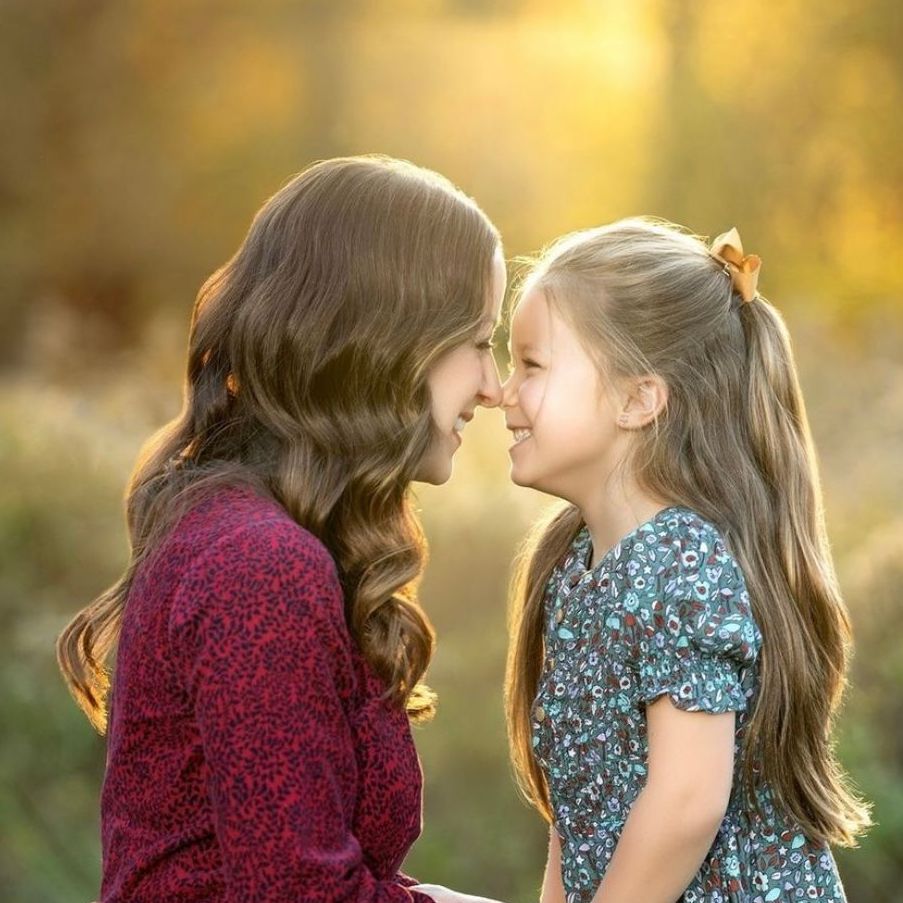 a woman and a little girl are looking at each other and smiling . natural makeup. pittsburgh, pa. family photos makeup. bridal mua. wedding makeup artist. moriah e beauty. kristin merck photography.