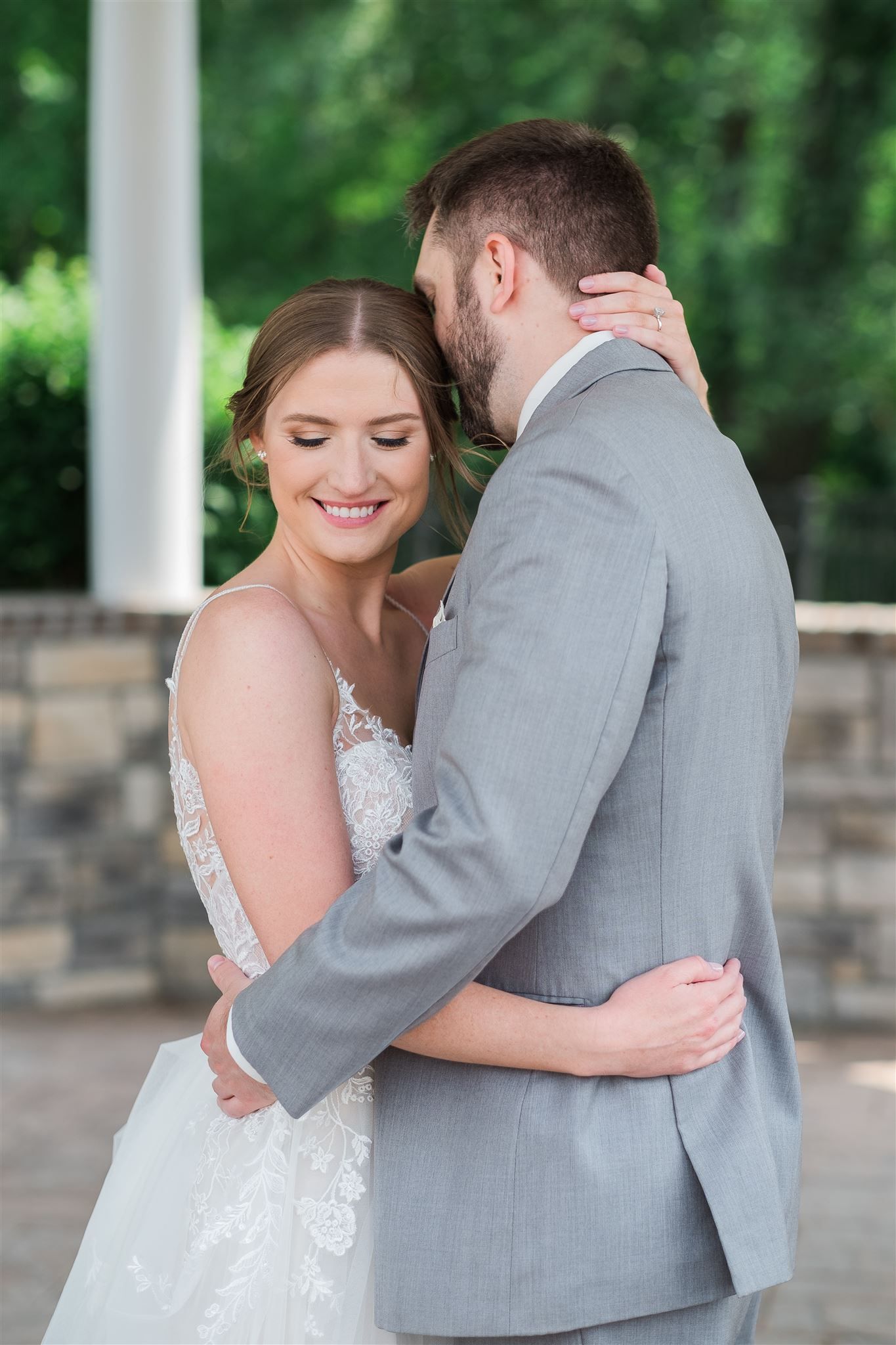 a bride and groom are hugging each other on their wedding day . natural wedding makeup. pittsburgh, pa. bridal makeup. bridal mua. wedding makeup artist. moriah e beauty. caitlin's living photography.