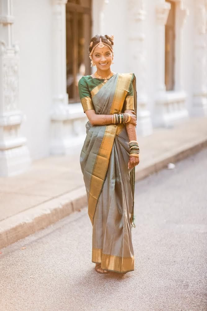 a bride in a green and gold saree is standing on a sidewalk . natural wedding makeup. pittsburgh, pa. bridal makeup. bridal mua. wedding makeup artist. moriah e beauty. jorge santiago photography.