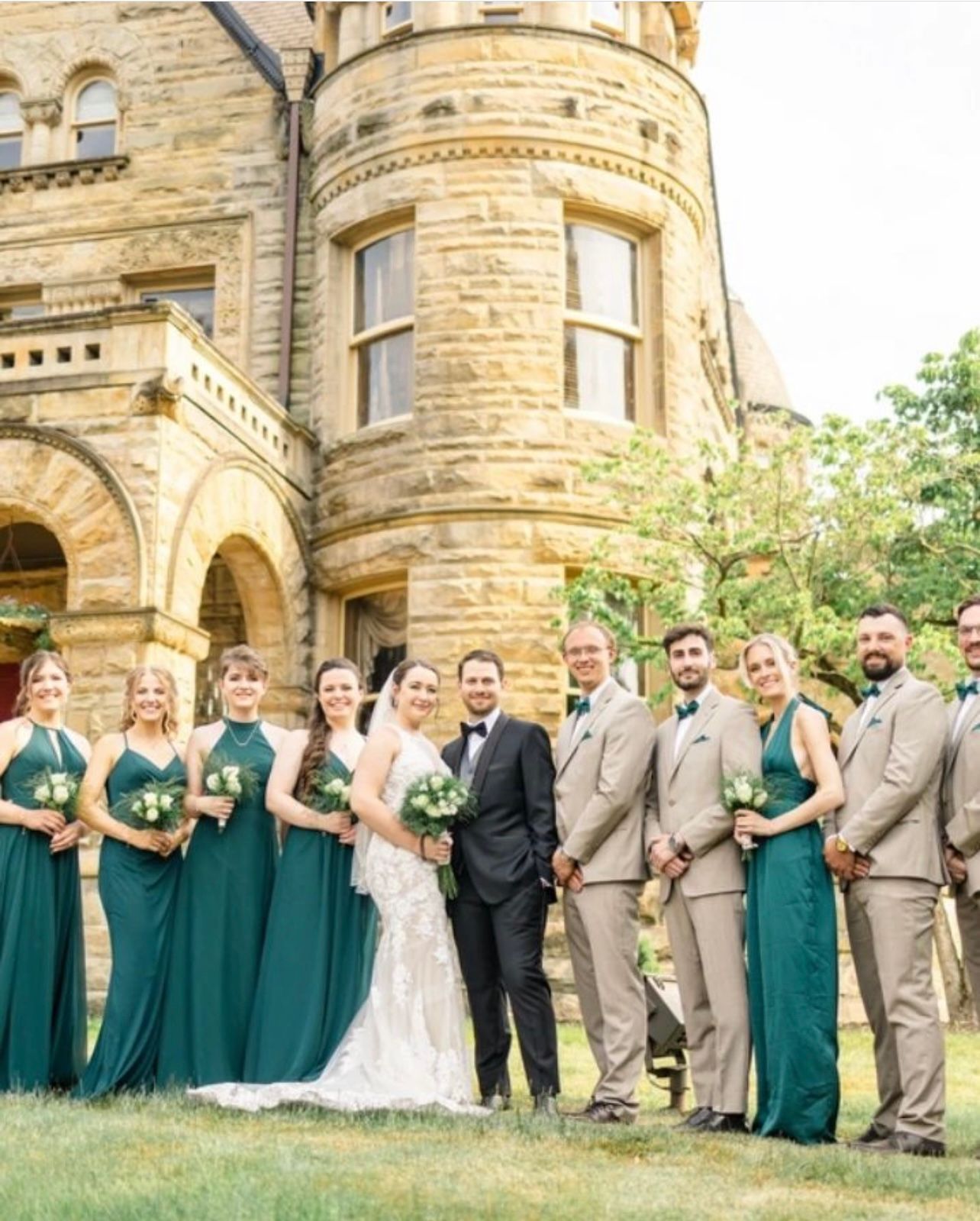 a bride and groom are posing for a picture with their wedding party in front of a castle . natural wedding makeup. pittsburgh, pa. bridal makeup. bridal mua. wedding makeup artist. moriah e beauty. danielle durbin film and photo.