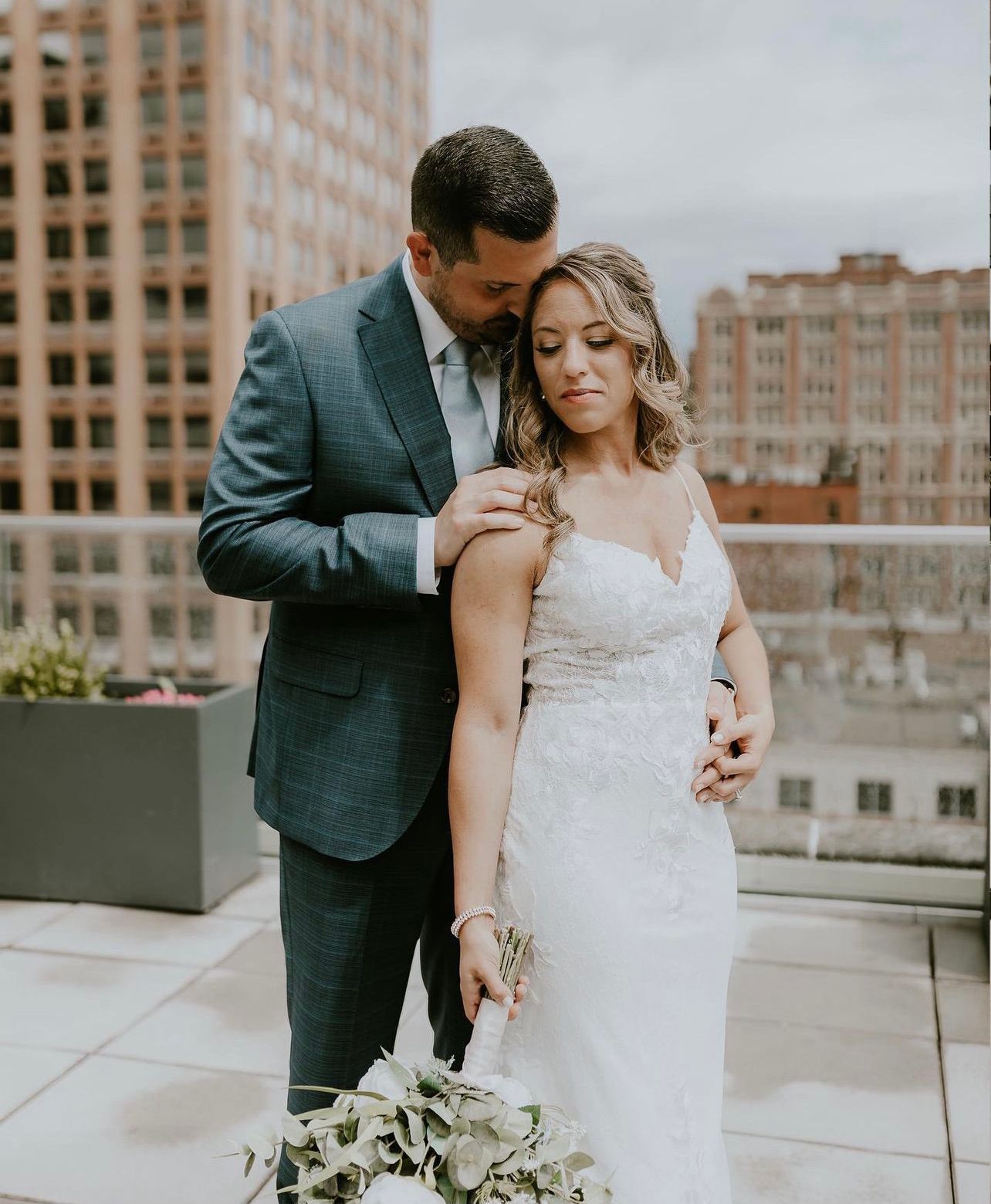 a bride and groom are posing for a picture on a rooftop . natural wedding makeup. pittsburgh, pa. bridal makeup. bridal mua. wedding makeup artist. moriah e beauty. jenna leix photography.