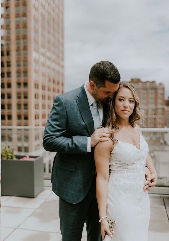 a bride and groom are posing for a picture on a rooftop . natural wedding makeup. pittsburgh, pa. bridal makeup. bridal mua. wedding makeup artist. moriah e beauty. jenna leix photography.