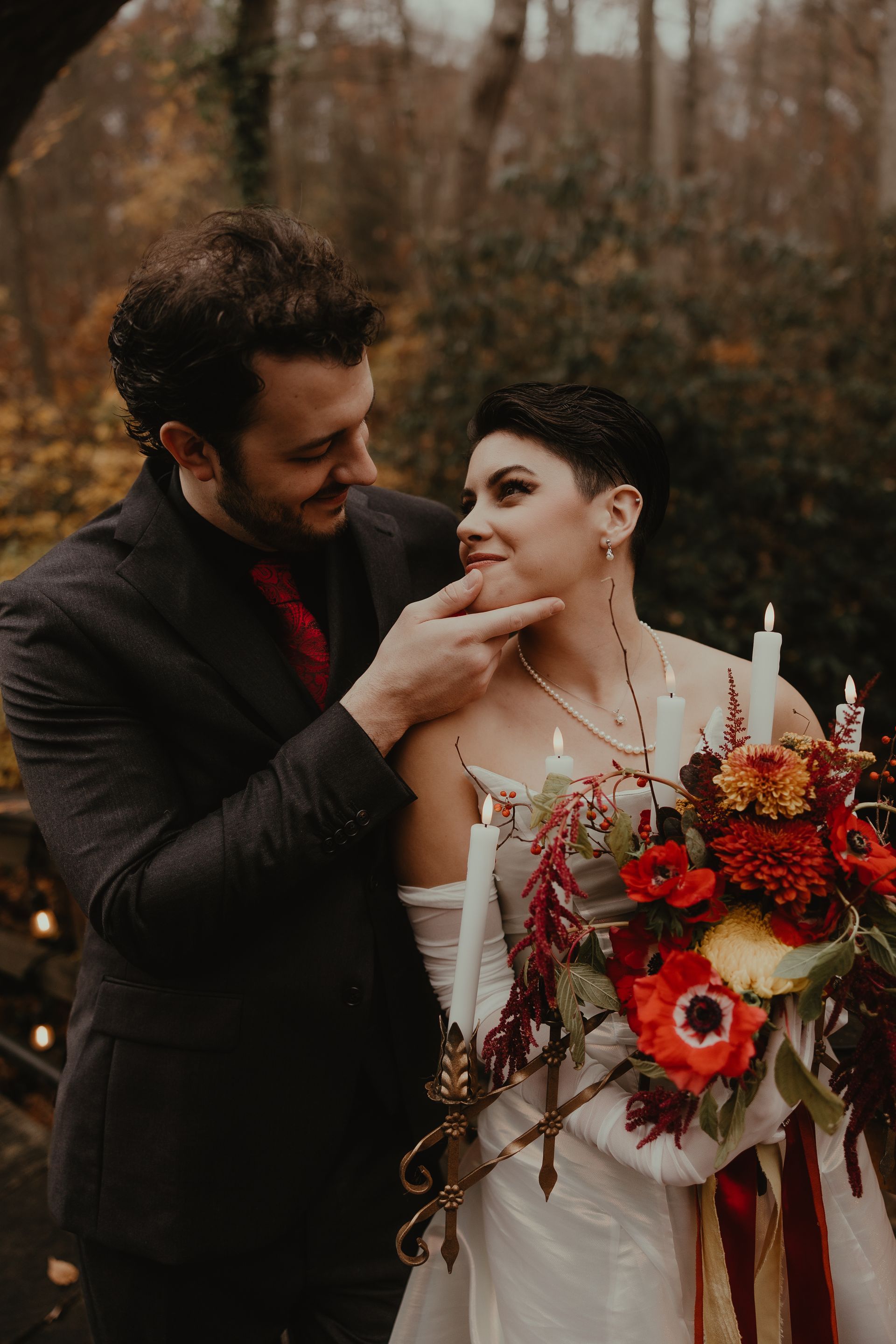 a bride and groom are posing for a picture in the woods with candles . glam wedding makeup. pittsburgh, pa. bridal makeup. bridal mua. wedding makeup artist. moriah e beauty. snaps by shawna photography.